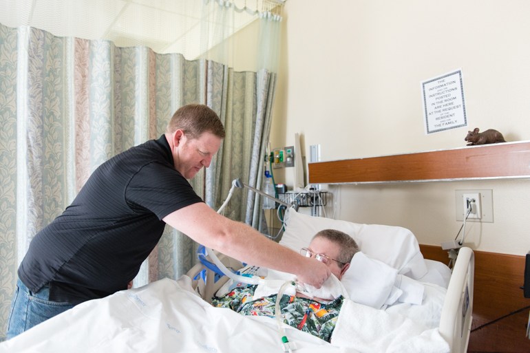 Jeremy Wilson, 40, cleans his father John Wilson’s mouth during his weekly visit at St. John’s Pleasant Valley Hospital in Camarillo, Calif., on Wednesday, February 24, 2016. (Heidi de Marco/KHN)