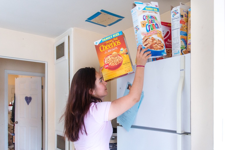 Sandy Roman, Benito Salgado’s wife, said they keep extra cereal around just in case they need it if disaster strikes. Only 38 percent of Latino households reported having a disaster plan, the lowest for any ethnic or racial group in the county. (Heidi de Marco/KHN)