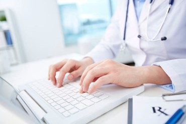 Modern medical person inputting diagnosis into an online data base