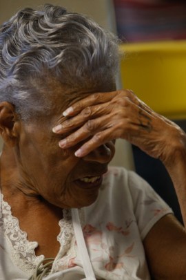 Willie Mae Rich, 86, rests after a short walk around her room. Nurse coordinator Andres Viles told Rich, “This bed is not your friend.” (Hal Yeager for California Healthline)