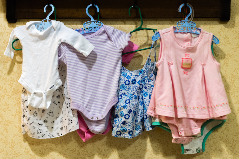Baby clothes hang on the wall of the nursery area at Sunrise Senior Living in Beverly Hills, California, on August 2, 2016. The nursing home has dedicated a section of the facility for residents participating in doll therapy. (Heidi de Marco/KHN)