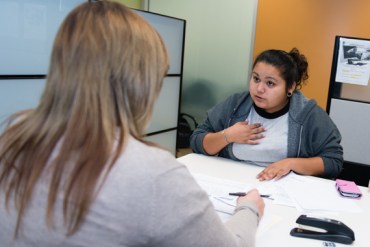 The eligibility worker at the Department of Public Social Services county office tells Marcy she needs proof that she was in foster care, Wednesday, Jan. 8, 2014, in El Monte, California. Without a universal database for foster children, social service providers have difficulty finding their records.