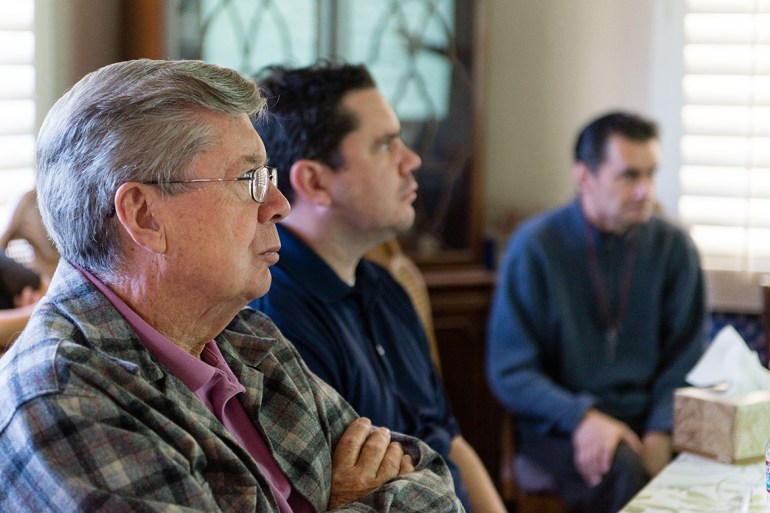 Relatives gathered around a dining room table as neurologist John Ringman gave a presentation about Alzheimer's disease and current research in Riverside, Calif., in 2015. (Heidi de Marco/California Healthline)