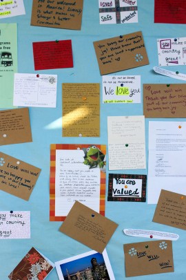 Messages of support for students are posted on several boards around the campus. The messages came from neighbors, staff, and people around the country. (Jocelyn Weiner for KHN)
