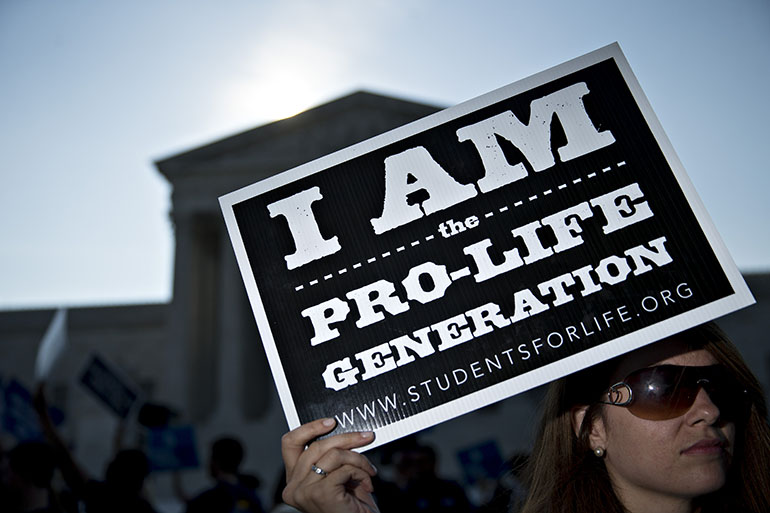 An anti-abortion advocate holds a sign outside the U.S. Supreme Court before rulings in Washington, D.C. on June 27, 2016. (Andrew Harrer/Bloomberg via Getty Images)