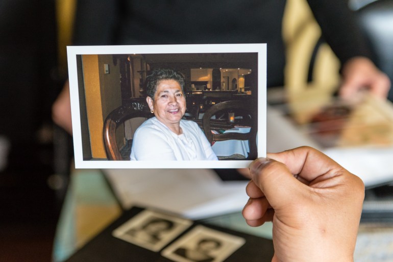 Mario Yanes holds a photo his mother, Blanca Rosa Rivera, a few years before she was diagnosed with Alzheimer’s disease. (Heidi de Marco/California Healthline)