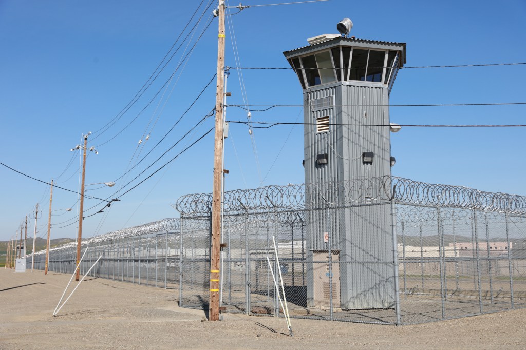 prison tower with barbed wire fence