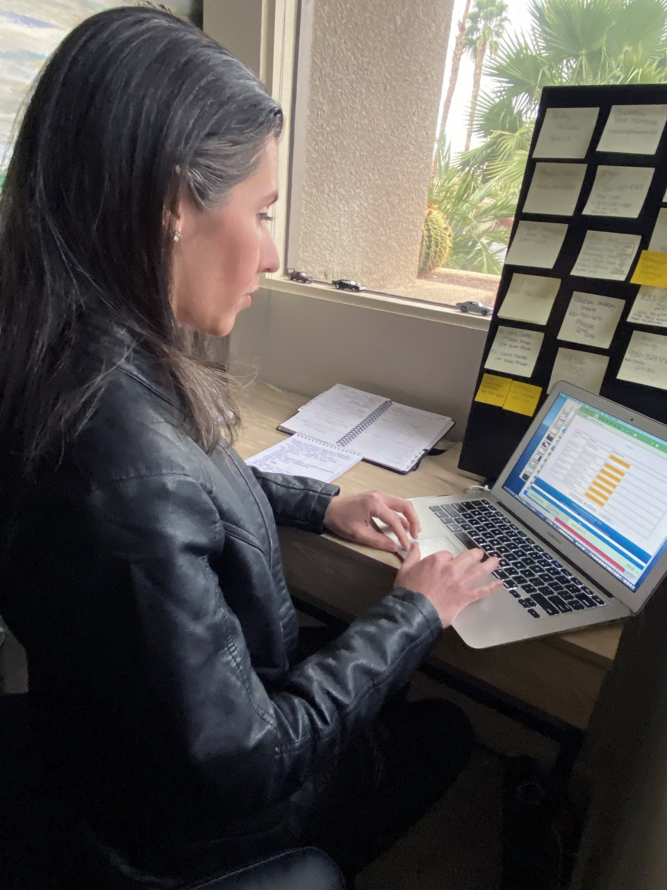 a woman sitting in front of a laptop