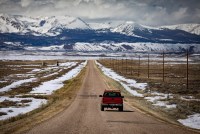 landscape of Walden, Colorado with a red truck on a rural road