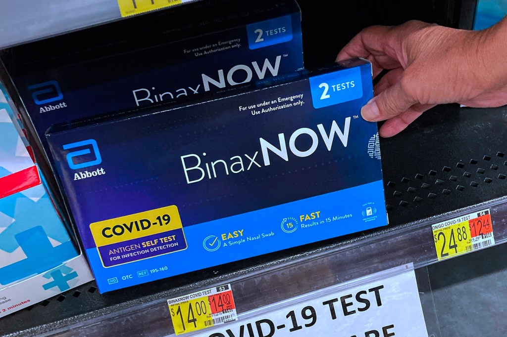 Covid-19 at-home rapid test kits are seen on a shelf at a Walmart Neighborhood Market in Orlando, Florida.