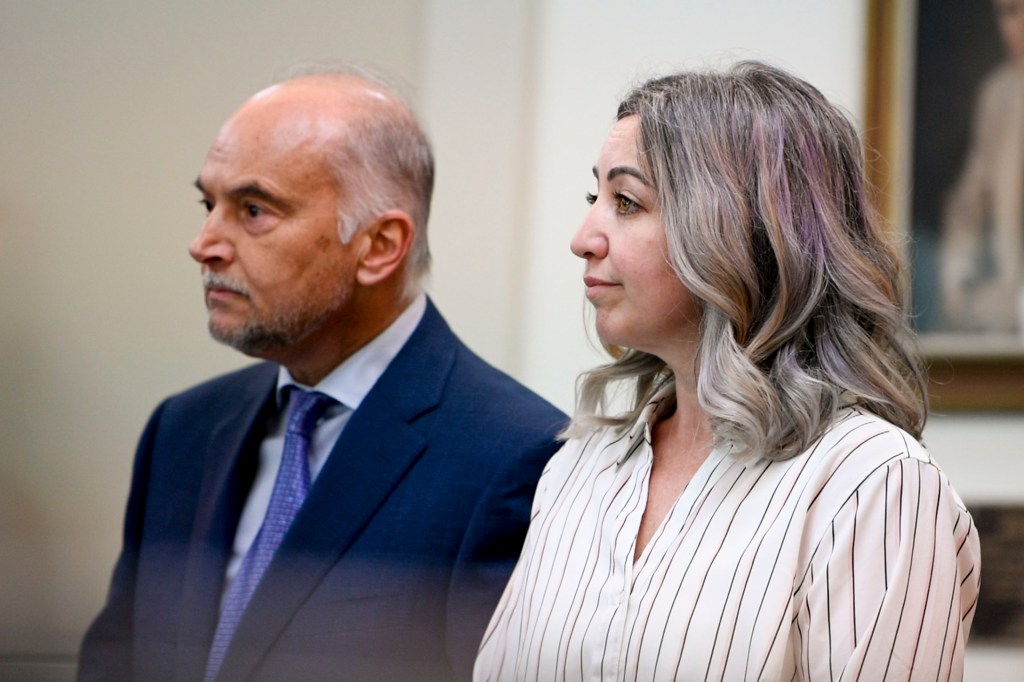 RaDonda Vaught is seen on the right of the image looking forward. Her attorney Peter Strianse stands on the left. They are in a court room.