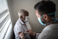 Nurse applying vaccine on patient's arm