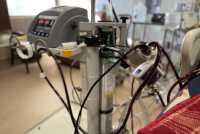 A closeup photo shows red tubes looping around an ECMO machine in a hospital room.
