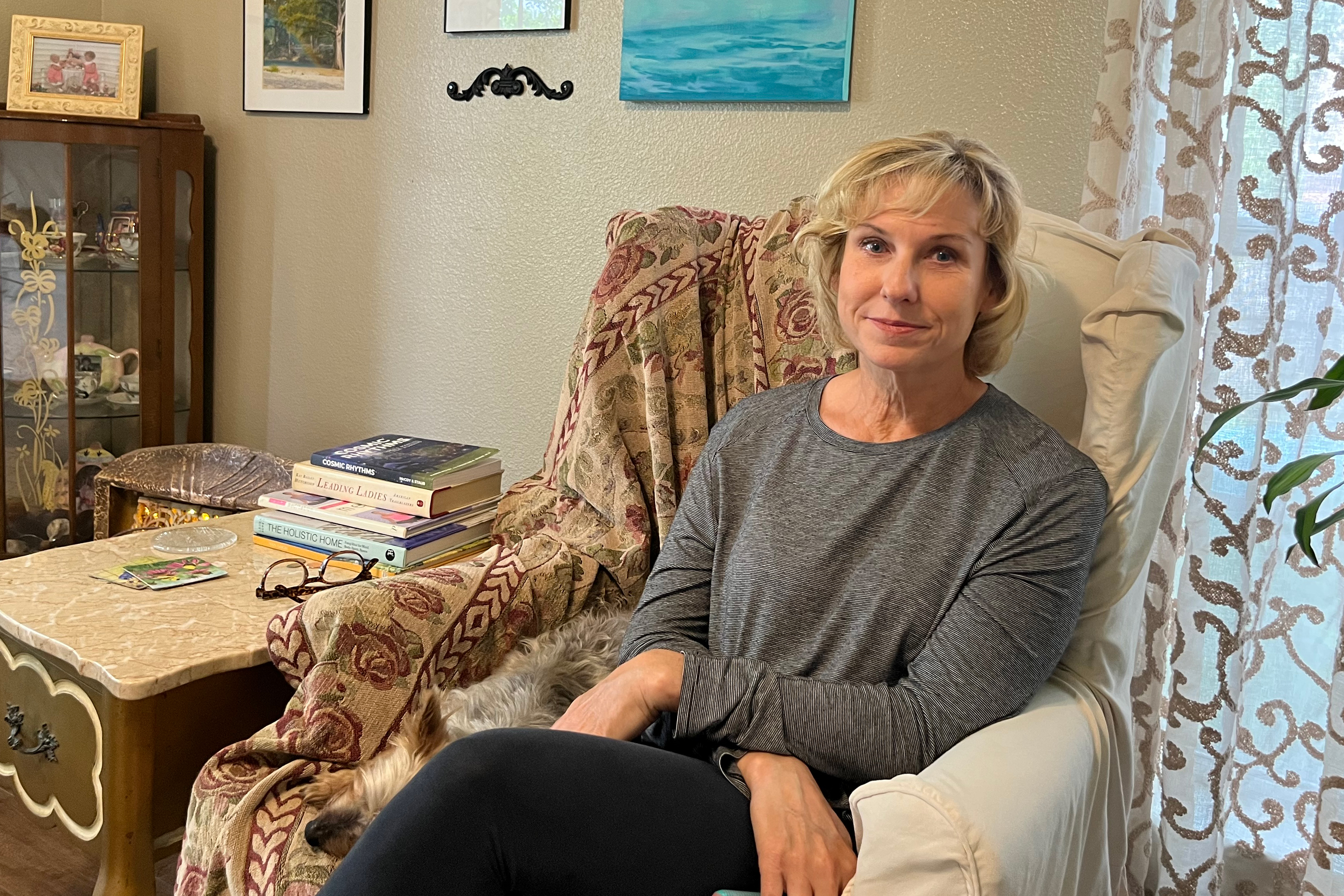 A photo shows Flo Rice sitting in a chair at home.