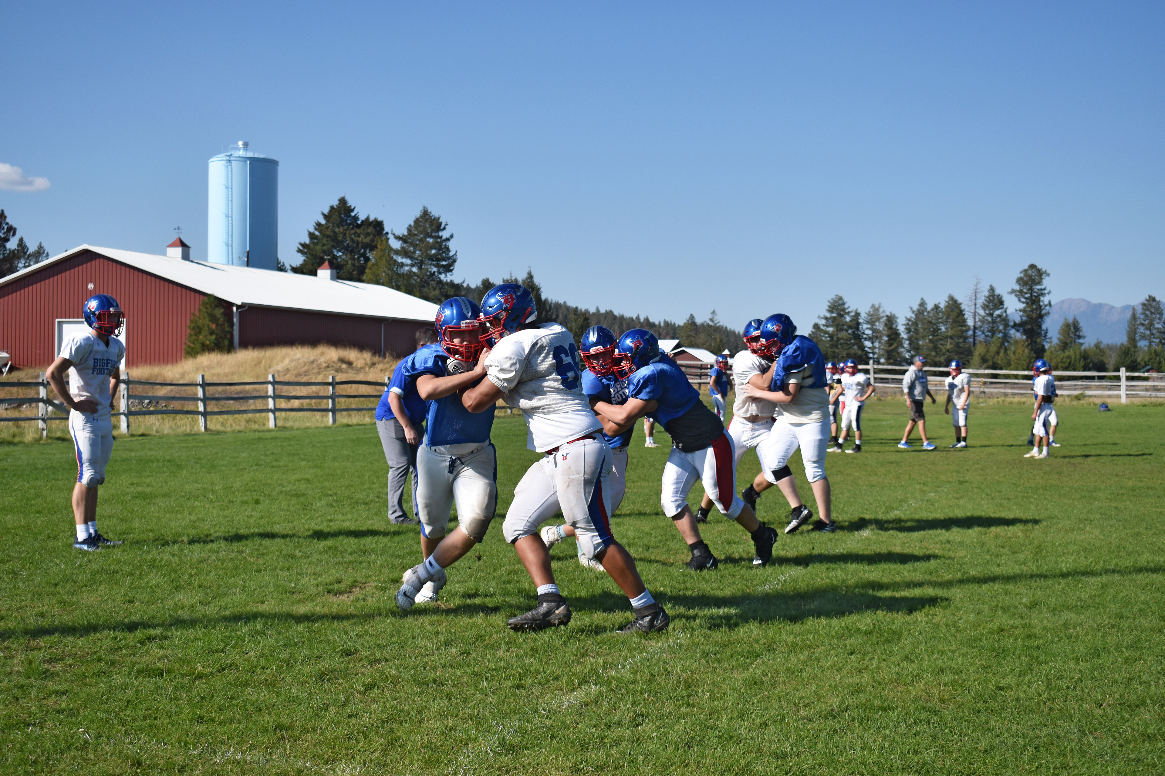 A photo shows members of the Bigfork Vikings football team practicing together on the field.