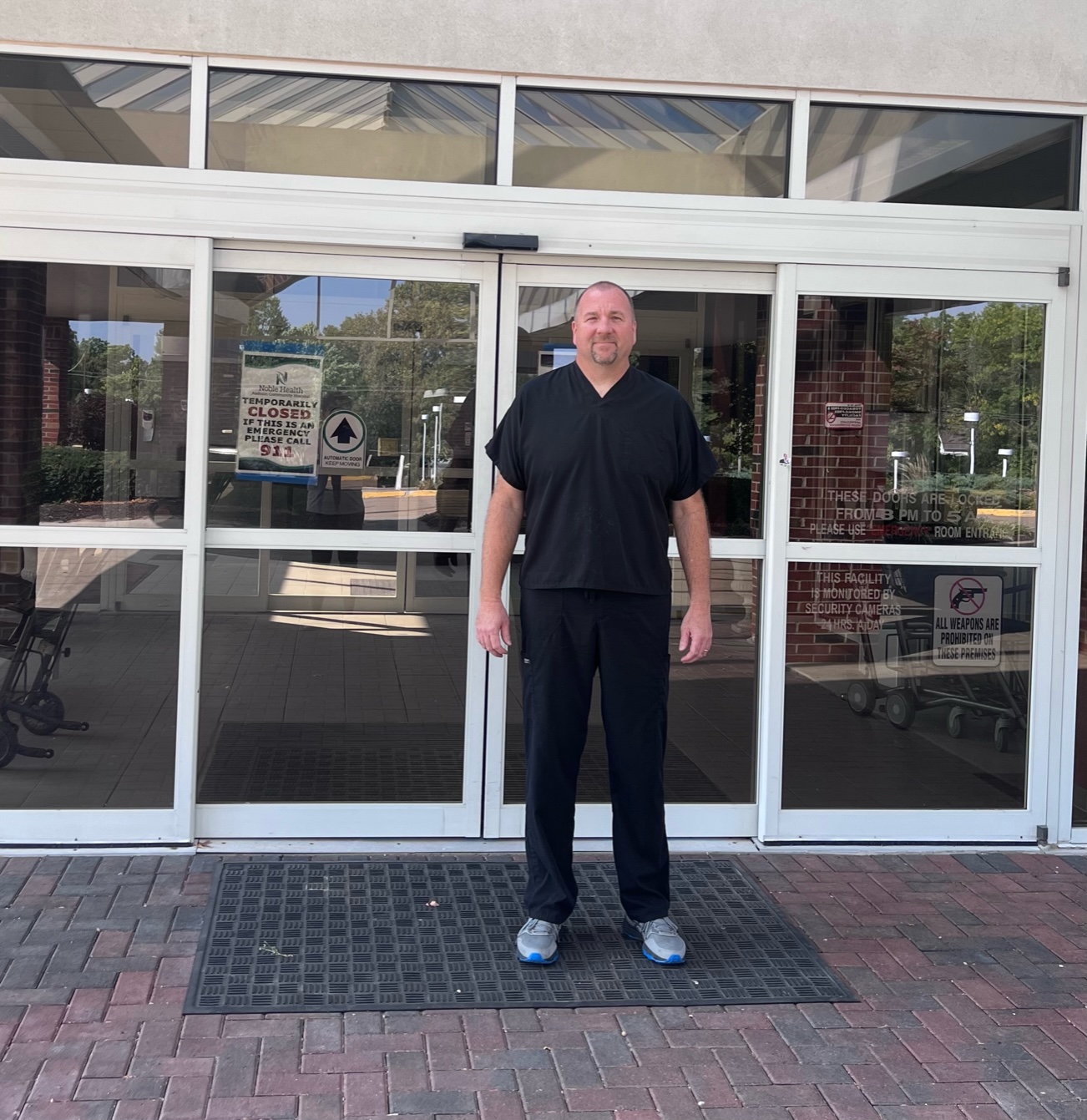 A photo shows Paul Huemann standing in front of the closed doors of Audrain Community Hospital.
