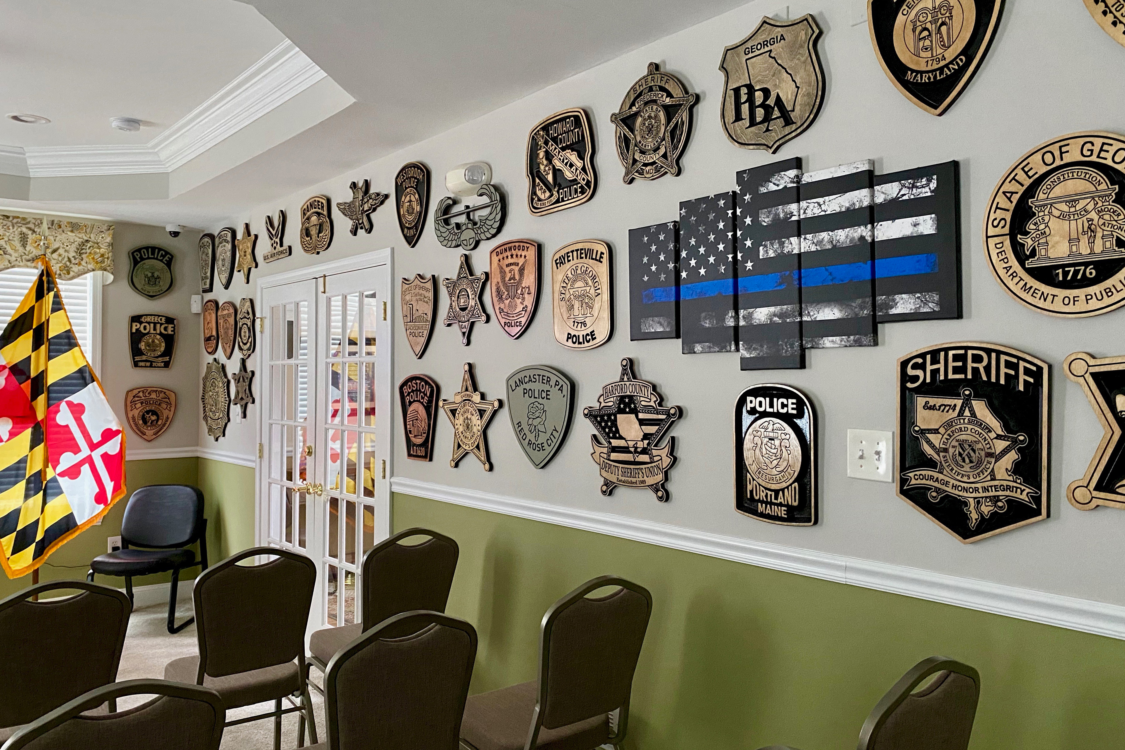 A photo shows a room with rows of chairs and walls that are decorated with plaques dedicated to law enforcement.