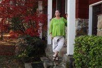 A photo shows Jennifer Smithfield standing on her porch outside her home.