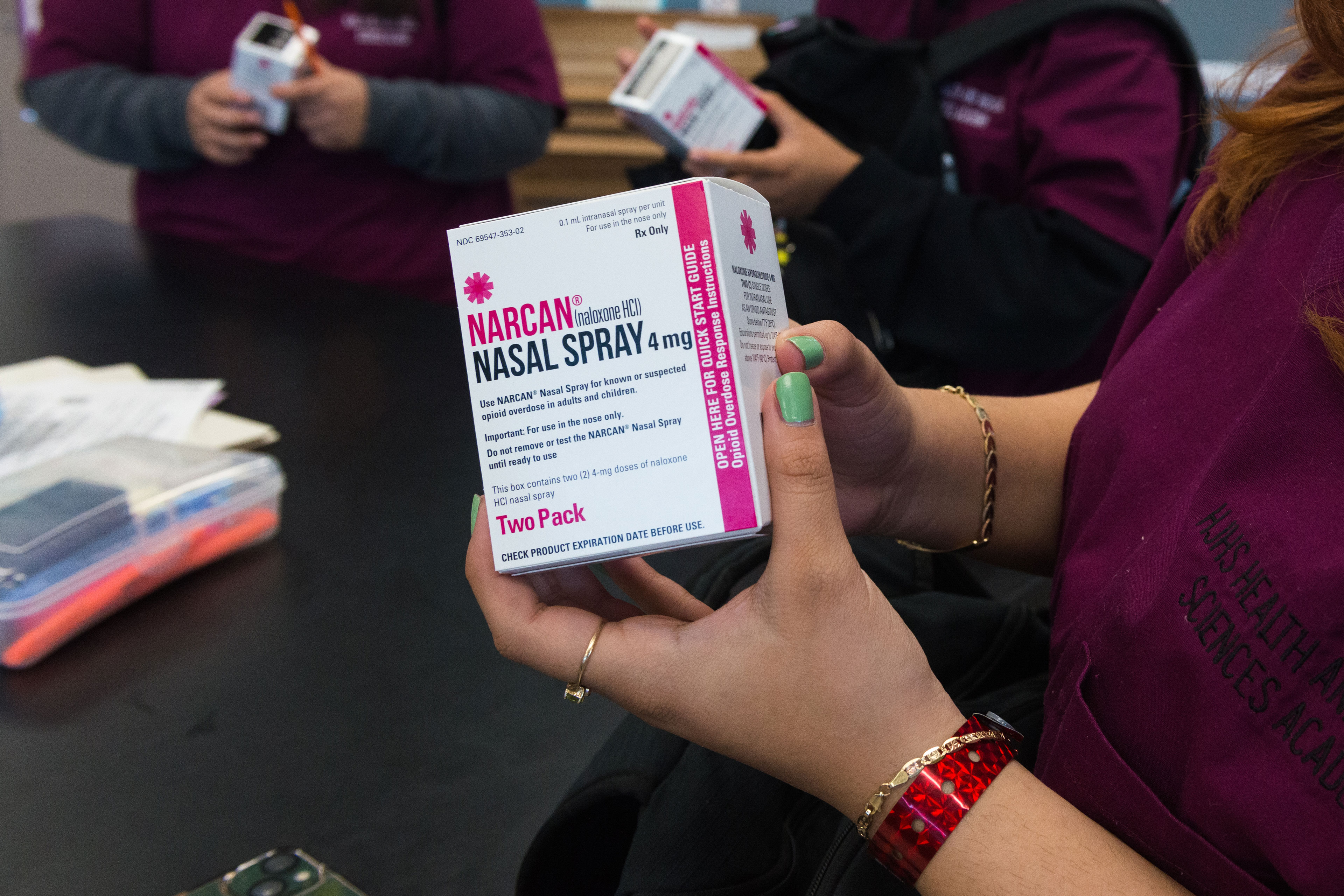 A close-up shot of someone holding a box labelled Narcan Nasal Spray.