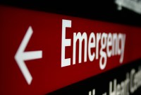 A photo shows a hospital emergency sign.
