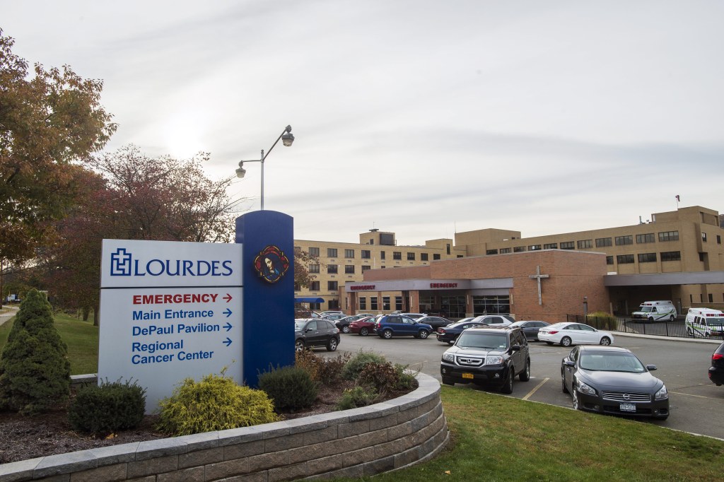 A photo shows the exterior of Our Lady of Lourdes Memorial Hospital.