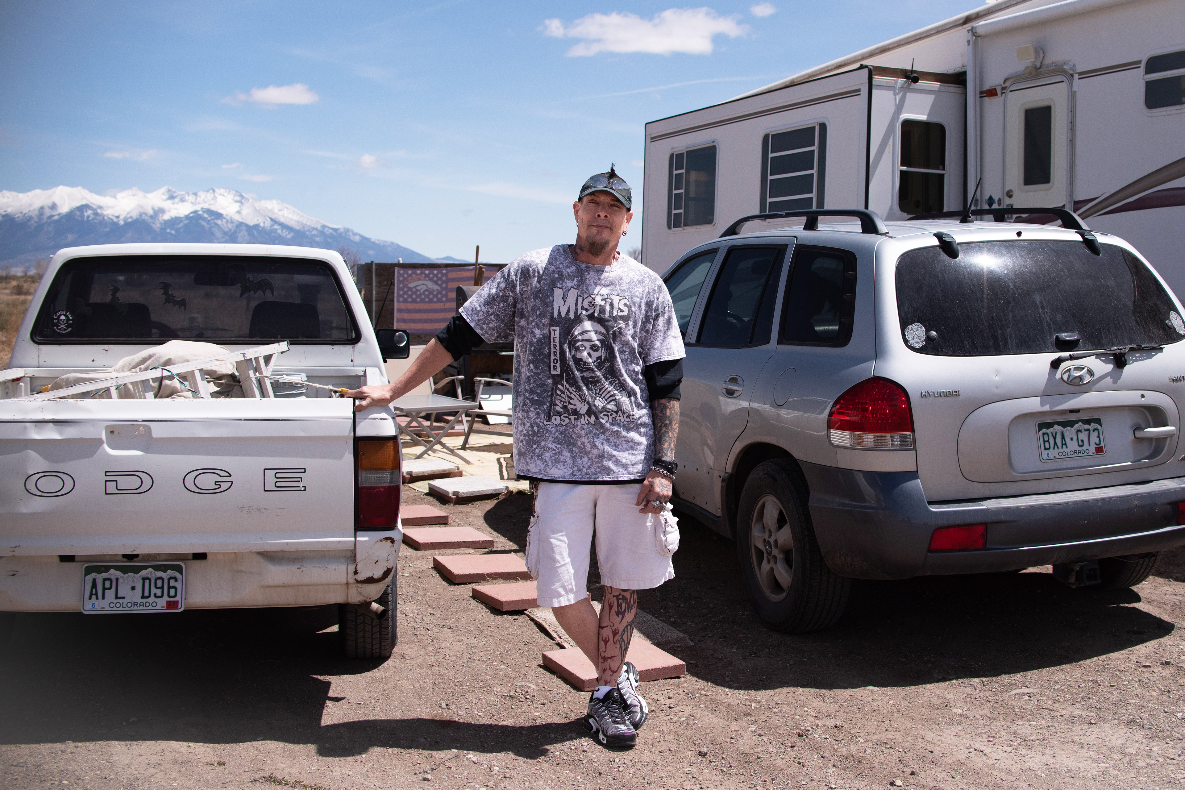 A photo of a man standing outside his trailer at a mobile home park.