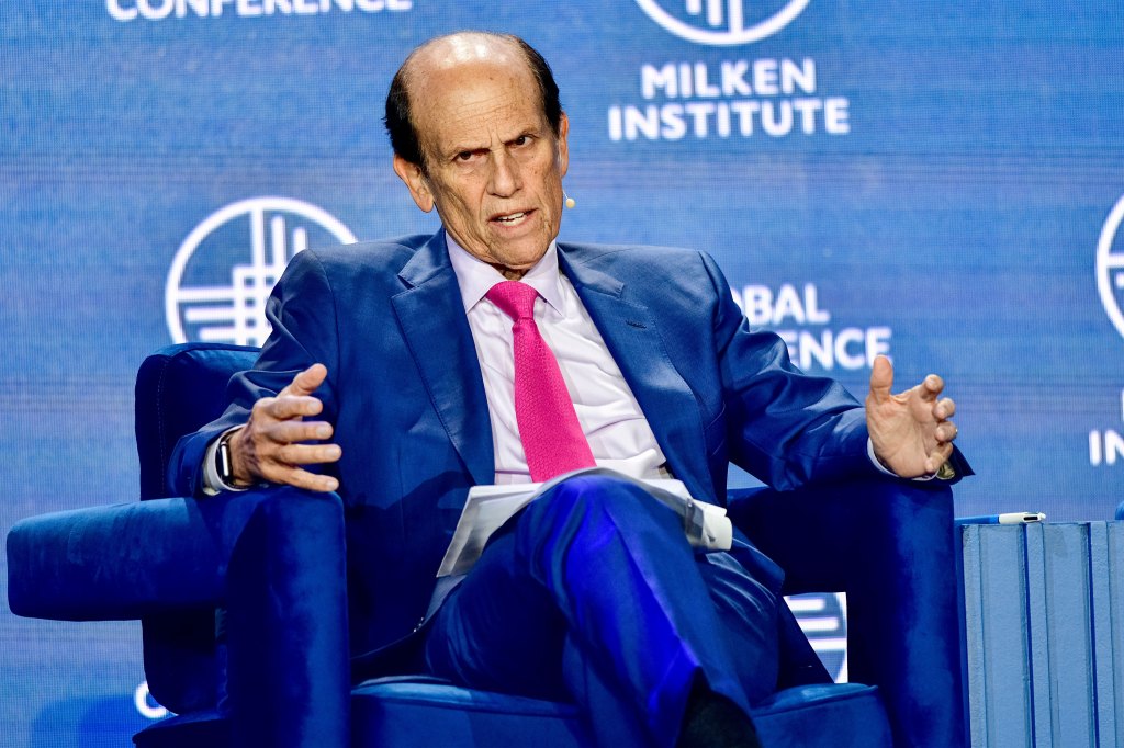 A photo of Michael Milken speaking at a conference.