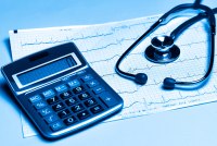 A blue-tinted photo illustration of an EKG reading, a calculator, and a stethoscope.