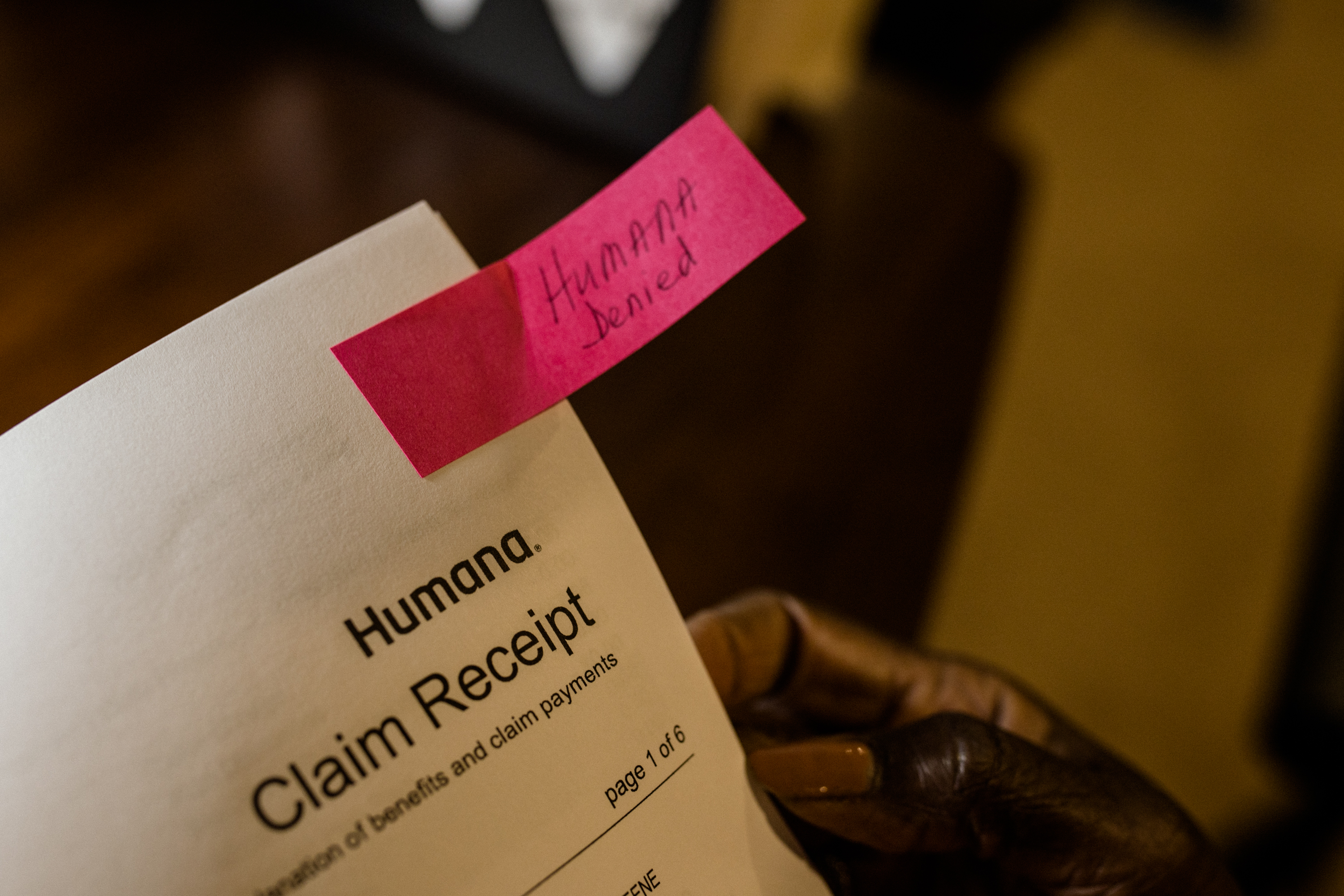 An up-close photo of an insurance claim. It reads, "Humana Claim Receipt". At the top right corner, there is a pink Post-It note that reads "Humana Denied" in script.