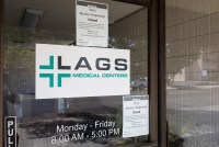 A photo of a Lags Medical clinic with closed signed on its door.