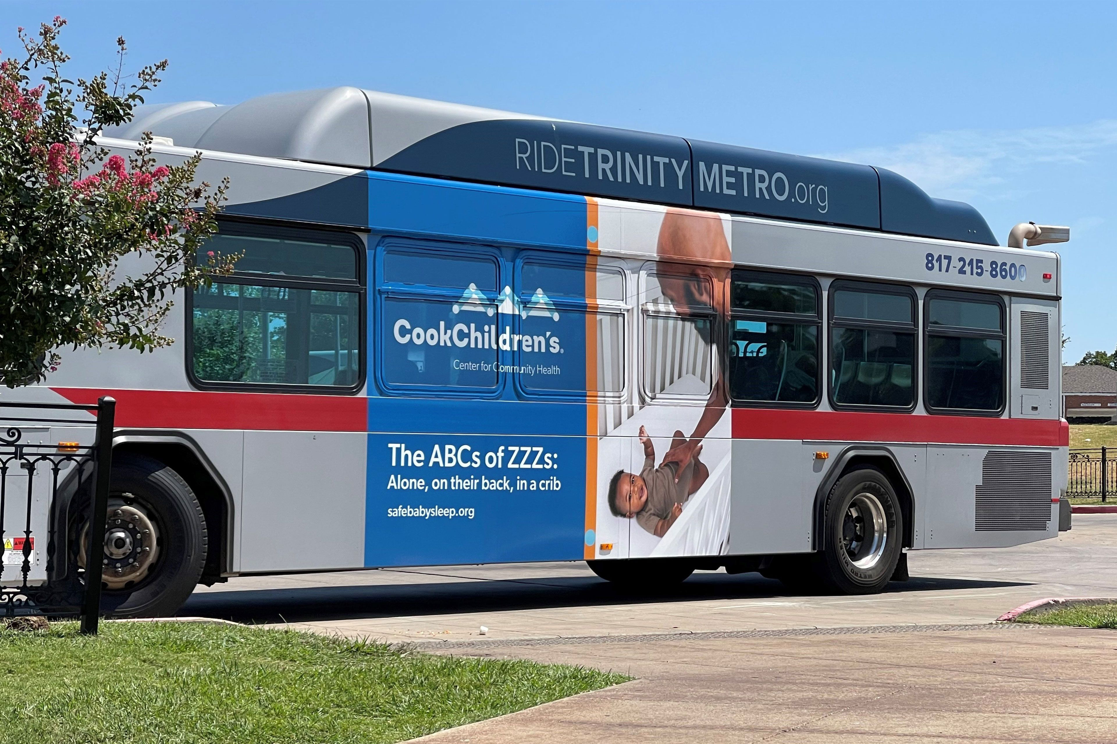 A photo of a bus with an advertisement about with safe infant sleep practices on it.