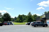 A photo of a Dollar General parking lot with a mobile health clinic van.