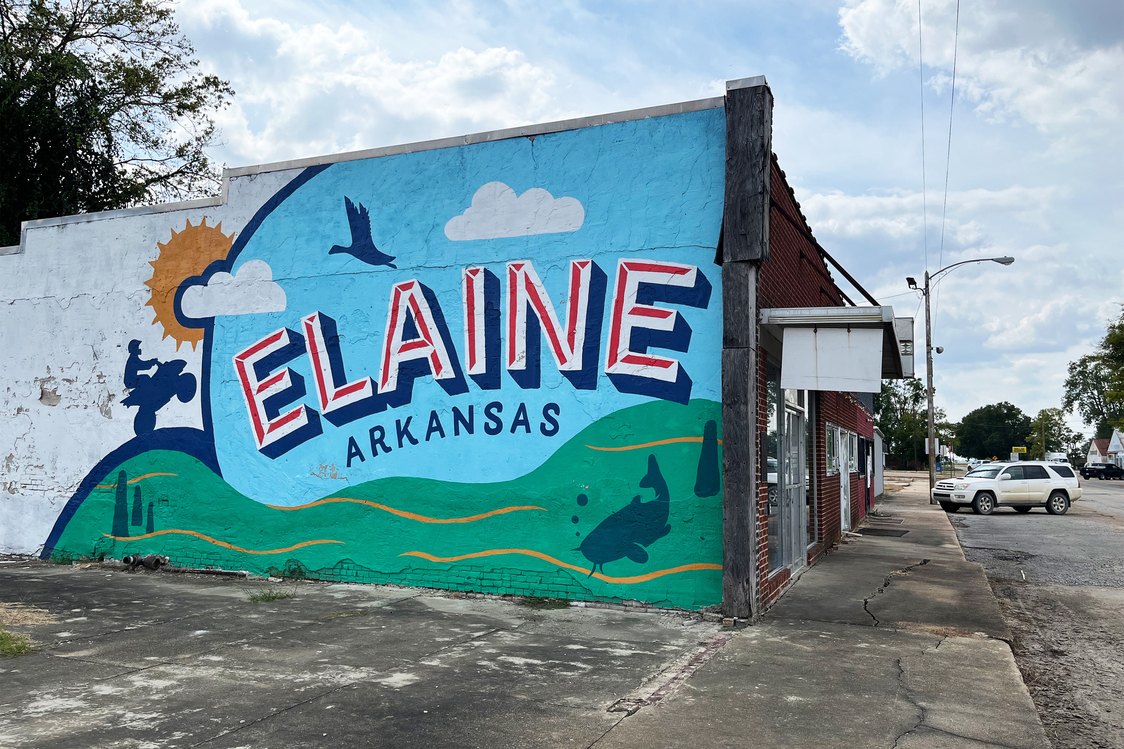 A photo of a colorful mural that reads, "Elaine, Arkansas," painted on the side of a building.