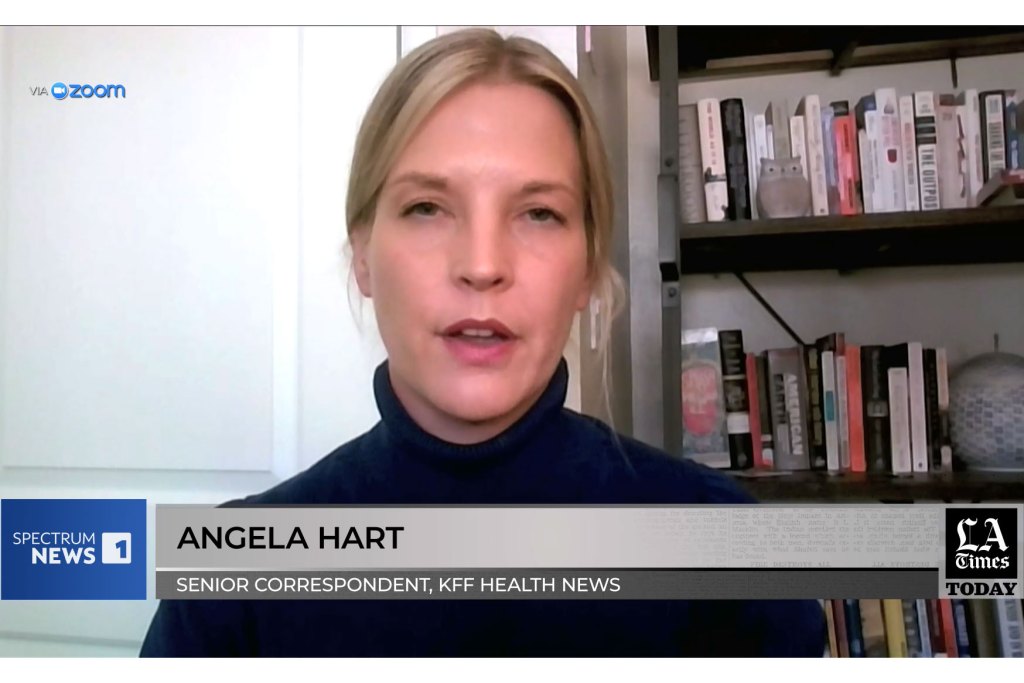 A screenshot of Angela Hart speaking to a camera. The lower third reads "Spectrum News 1", Angela Hart, Senior Correspondent, KFF Health News", and "LA Times Today".