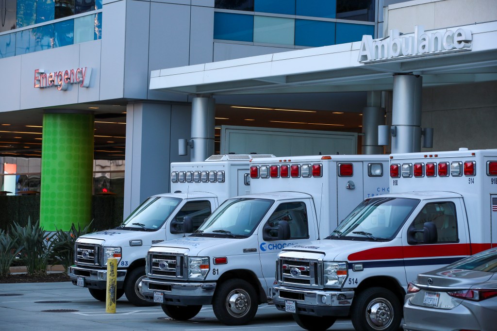 Three ambulances are lined up outside of an emergency room of a children's hospital in Orange, CA.