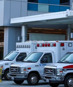 Three ambulances are lined up outside of an emergency room of a children's hospital in Orange, CA.