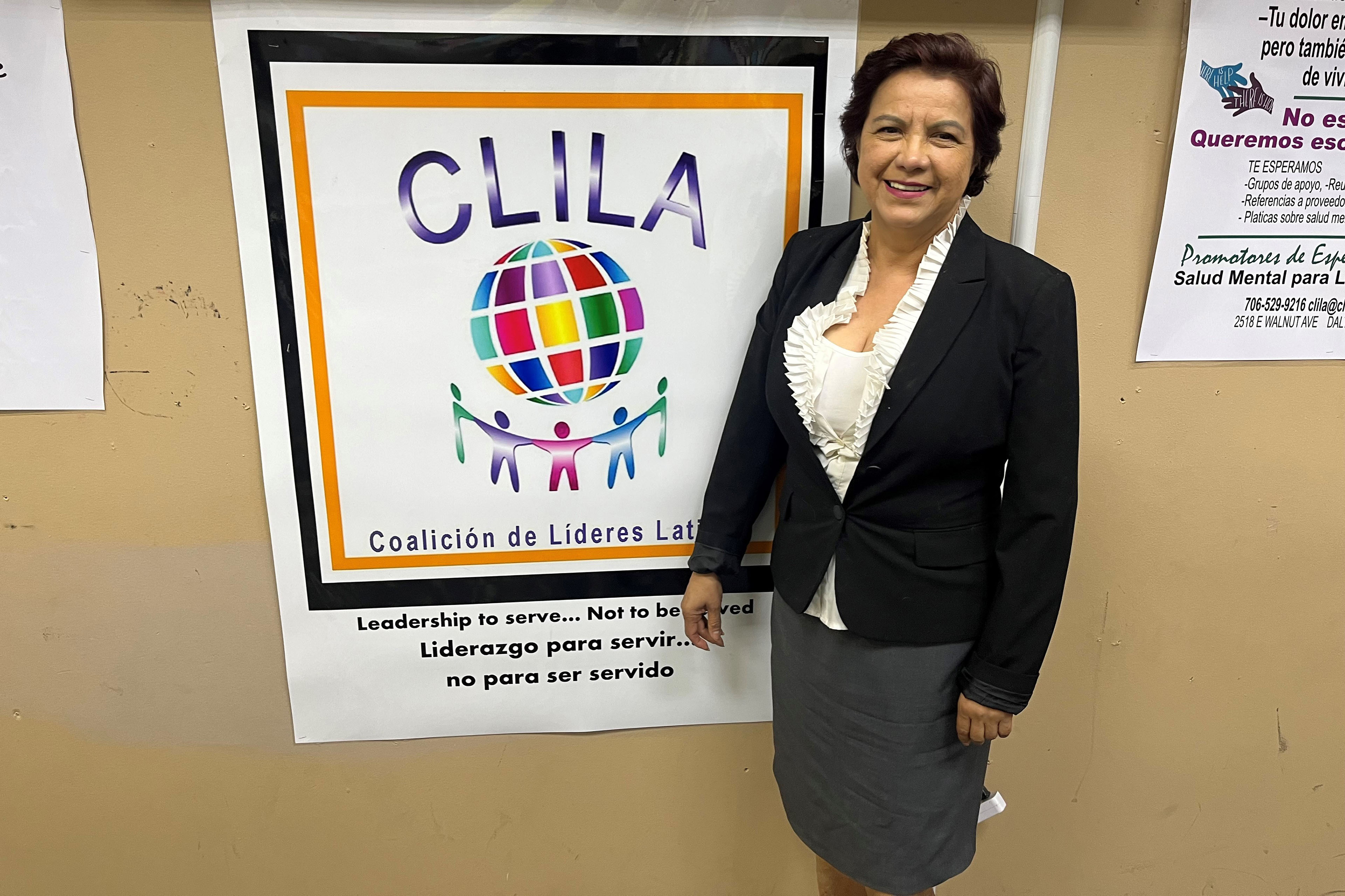 America Gruner stands beside a poster in Spanish that reads, "CLILA / Coalición de Líderes Lat[inos]."