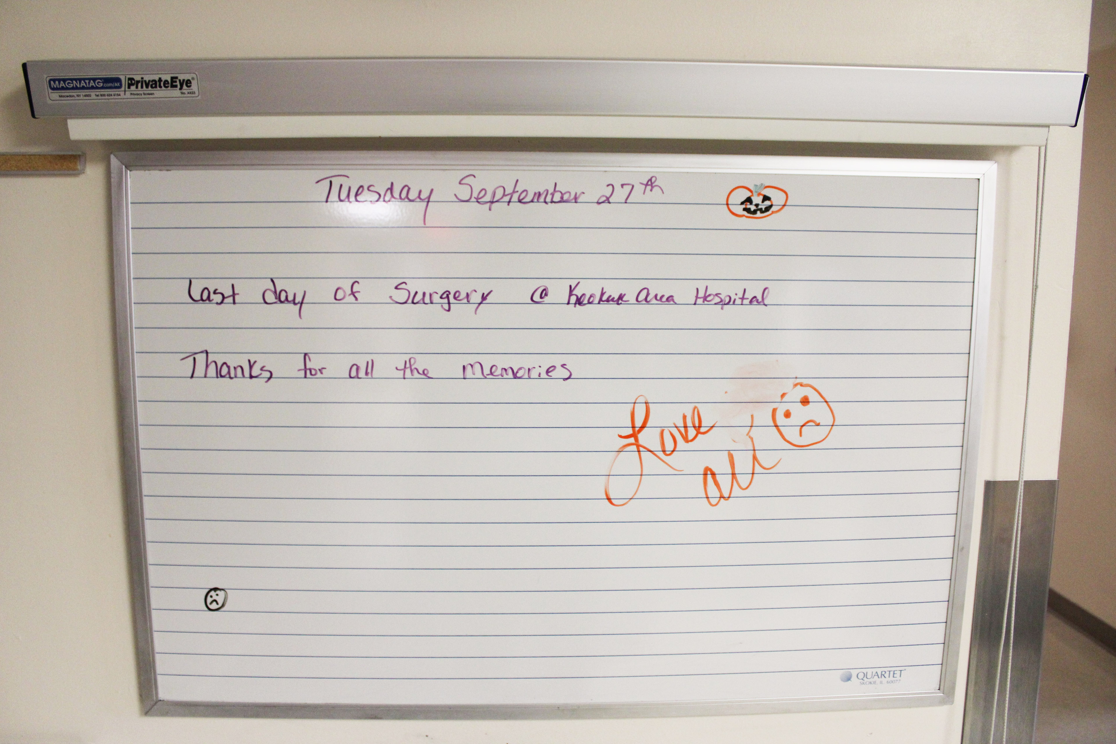 A white board inside the hospital reads, "Tuesday September 27th / Last day of surgery @ Keokuk Area Hospital / Thanks for all the memories / Love, all"