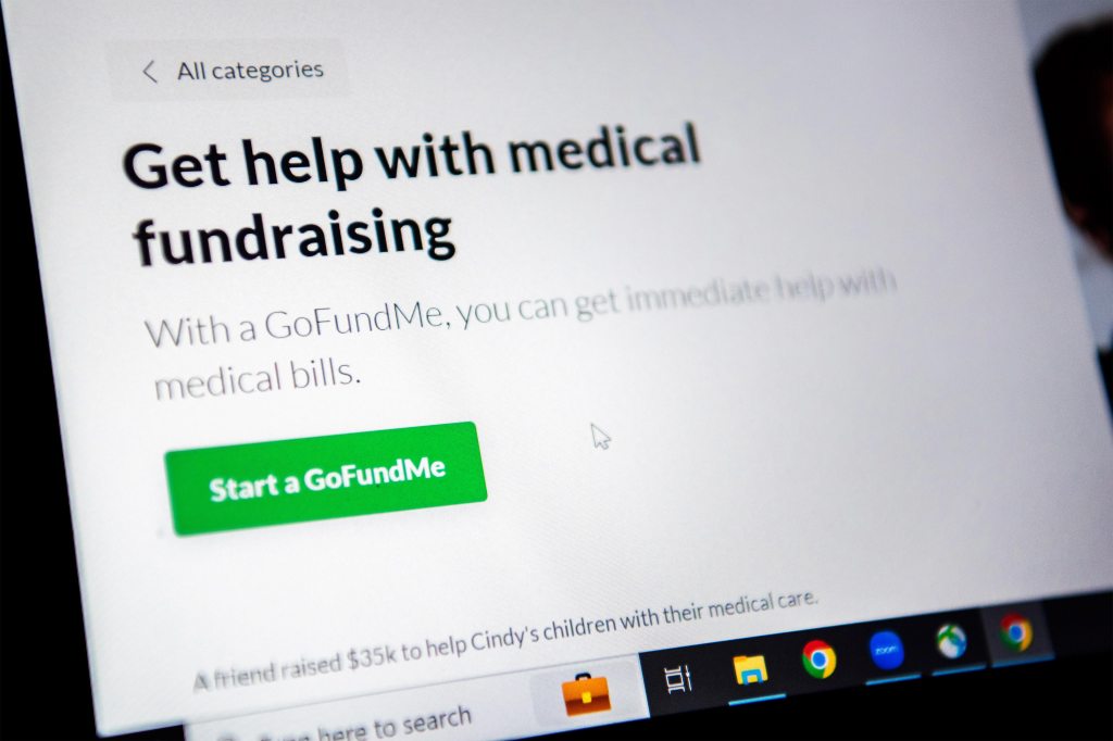 A photo of a laptop screen on GoFundMe's medical fundraising webpage. Text on the screen reads, "Get help with medical fundraising."