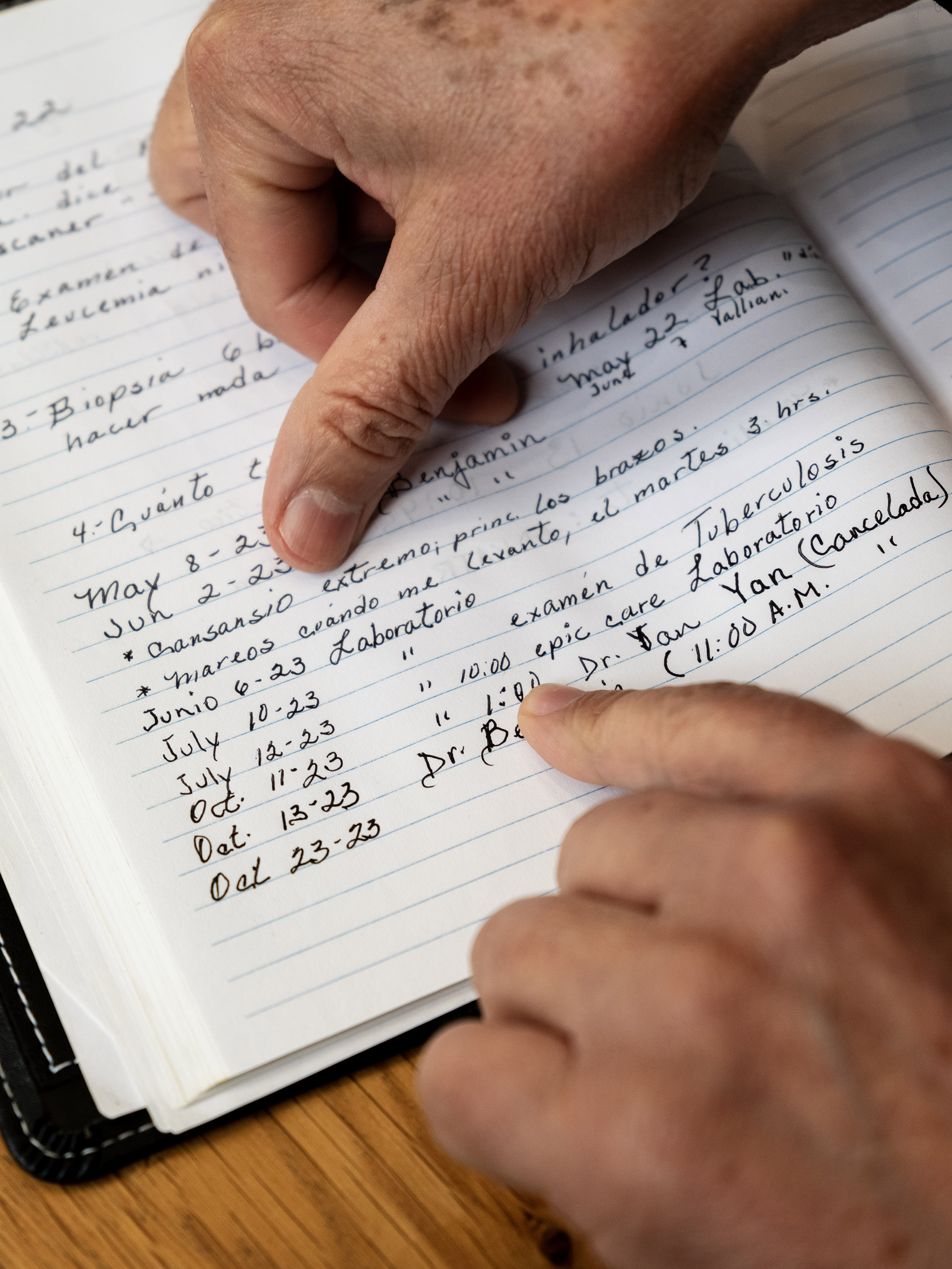 A close up photograph of a notebook Abundis uses to log his medical ailments and appointments.