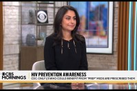 A screenshot shows Céline Gounder sitting at a table on a TV news set. Text on the screen reads, "HIV prevention awareness. CDC: Only 1/3 who could benefit from "PrEP" meds are prescribed them."
