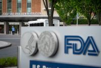 A photo of a sign with the FDA's logo in front of its headquarters.