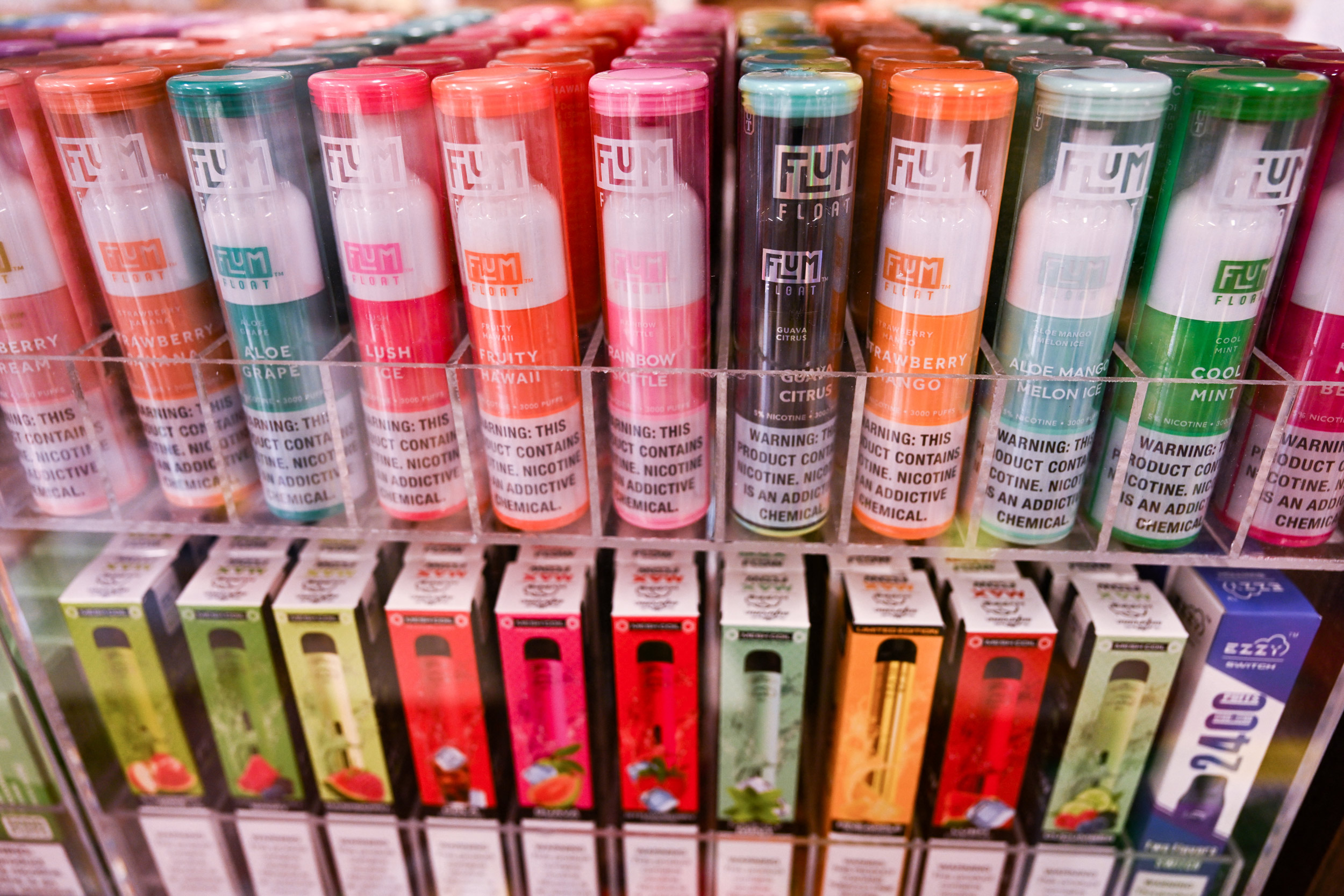 A photo of colorful disposable vapes shown inside a convenience store.