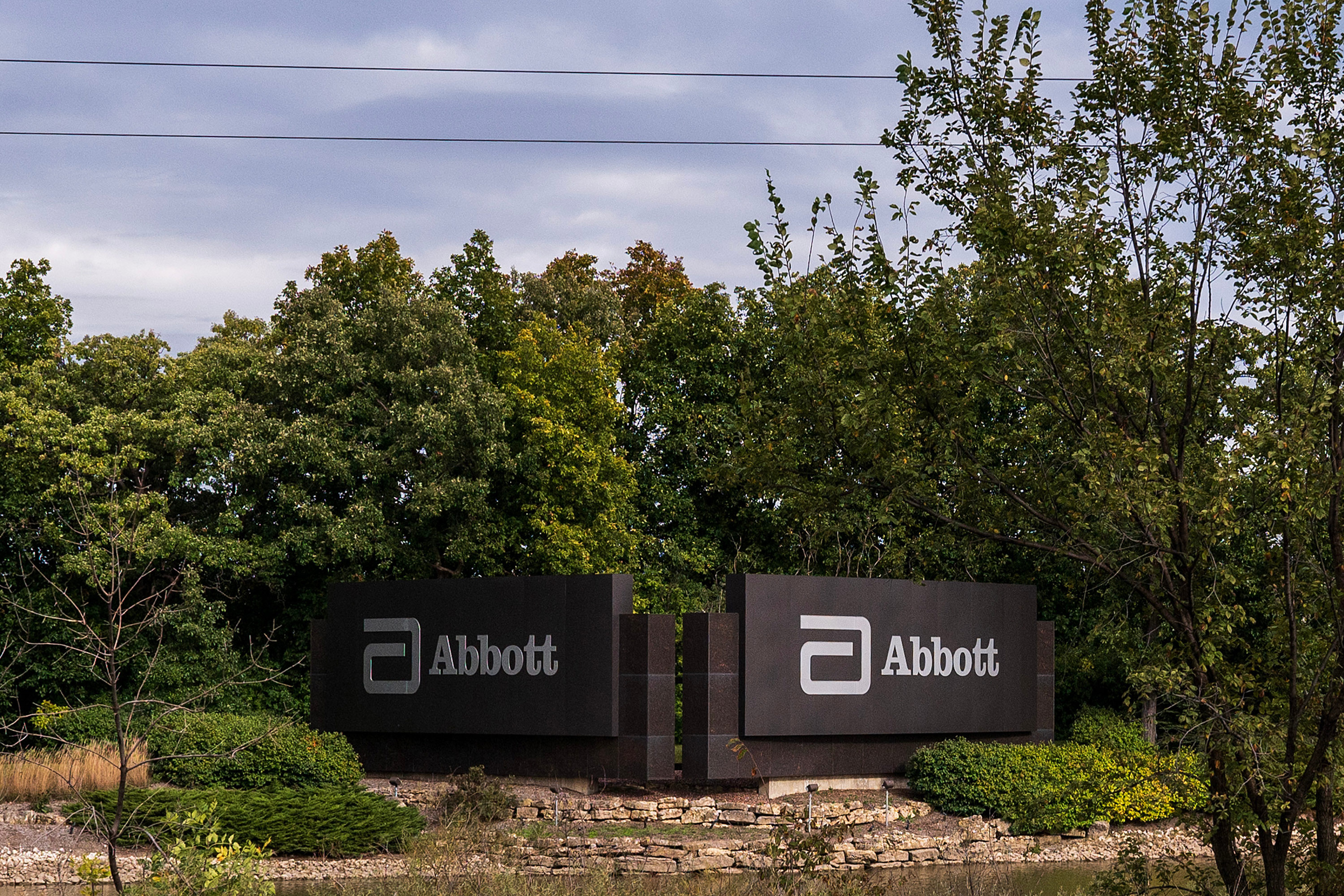 A photo of a sign with Abbott's logo outside of its headquarters.