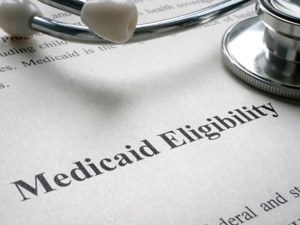 A photo of a piece of paper that reads, "Medicaid Eligibility" with a stethoscope on top.