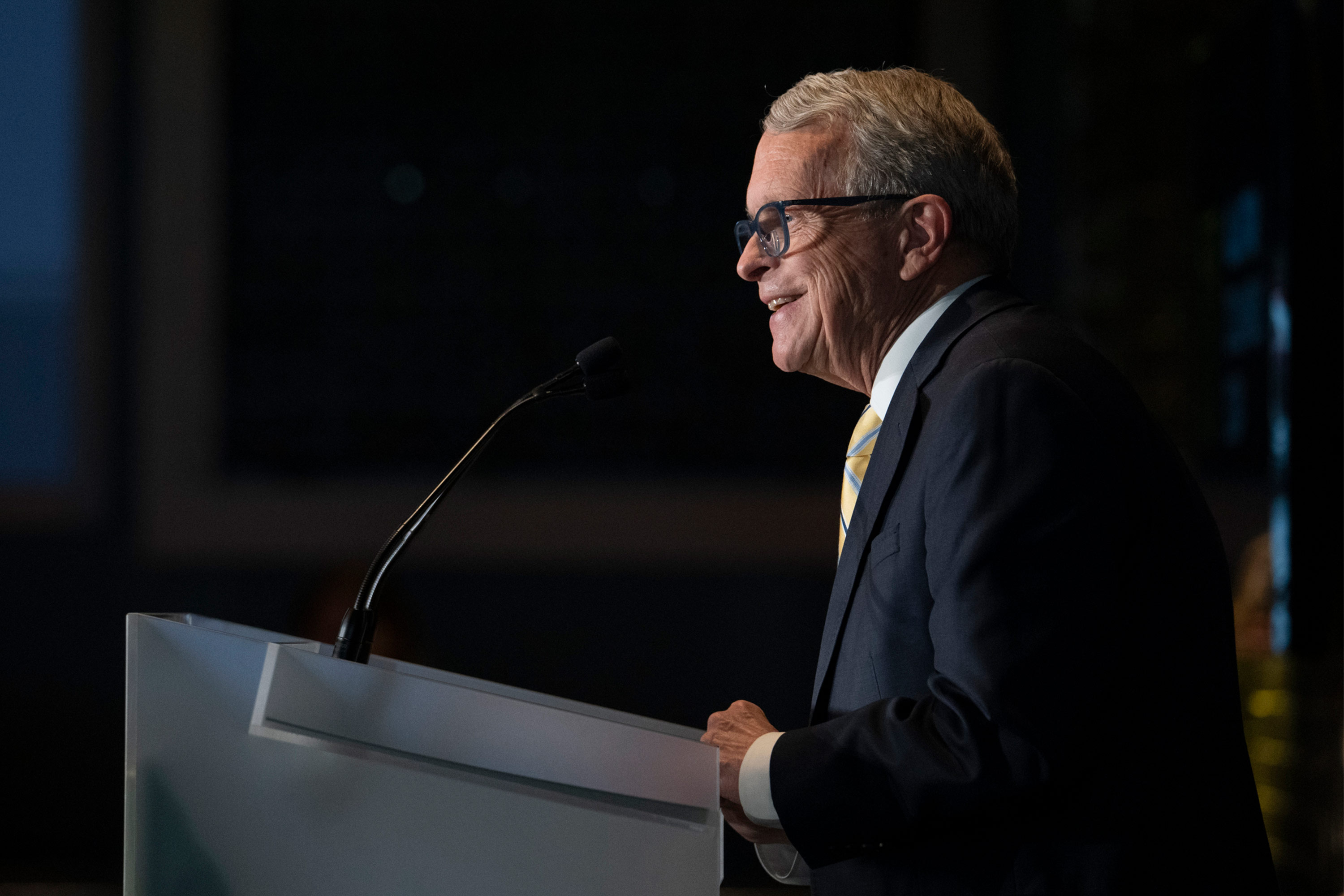 A photo of Gov. Mike DeWine speaking at a podium at a press conference.