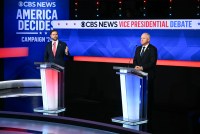 A photo of JD Vance and Tim Walz standing at podiums in a TV studio.