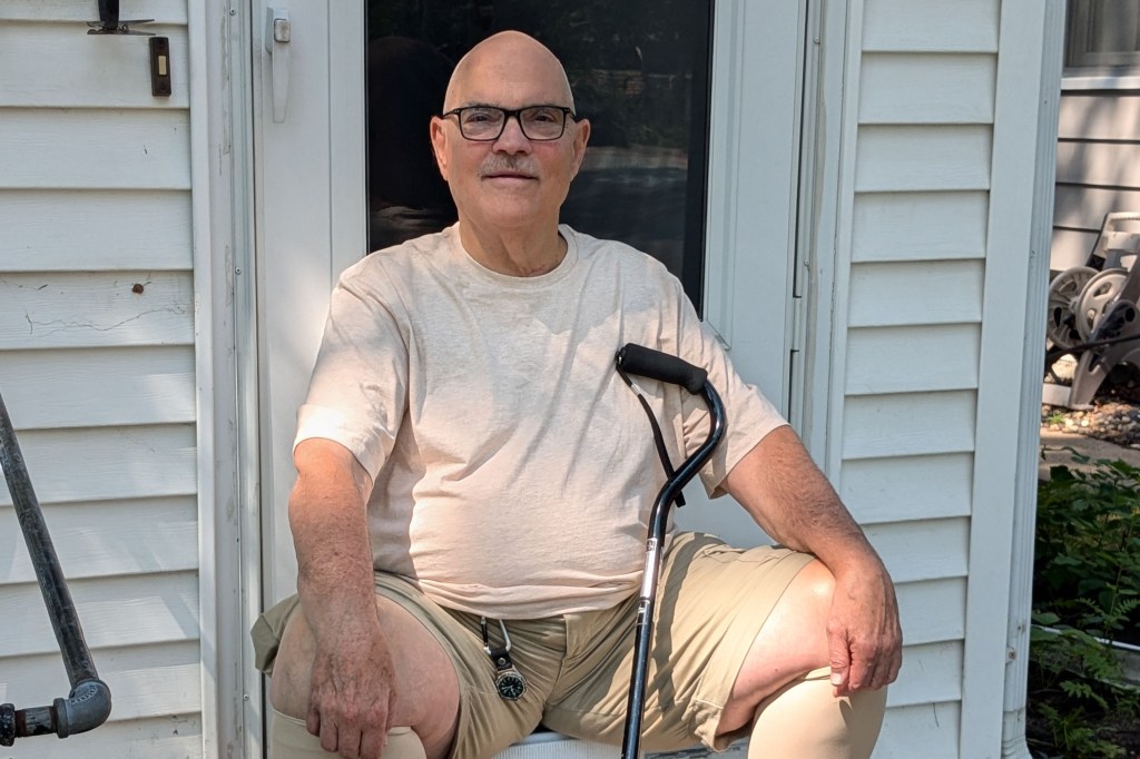 Donald Hammen, an 80 year old man, sits on the front steps to his house.