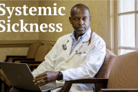 A portrait of a doctor sitting in a chair and looking towards the viewer.