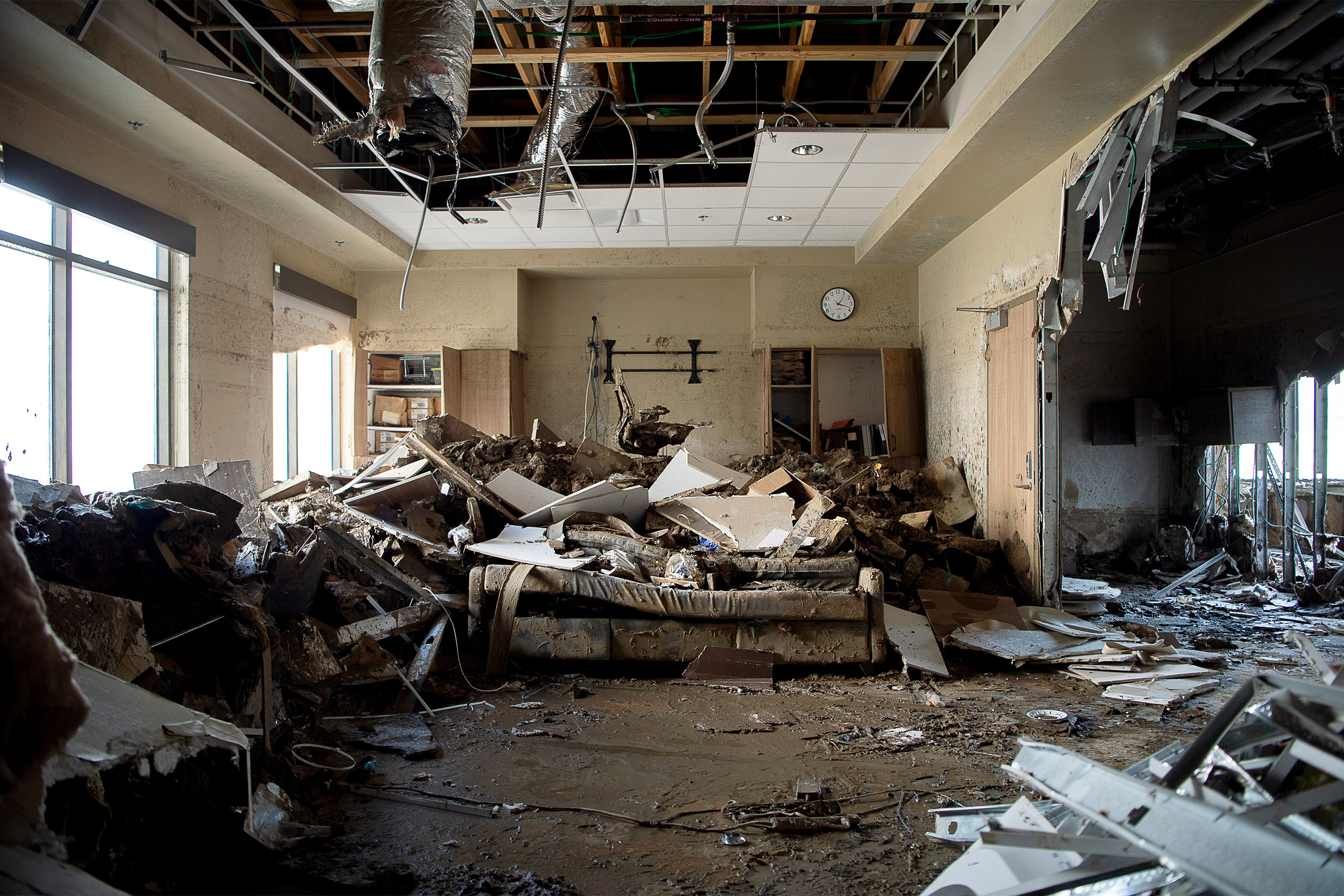 A photo of an interior in Unicoi County Hospital. A sofa lies crushed under rubble.